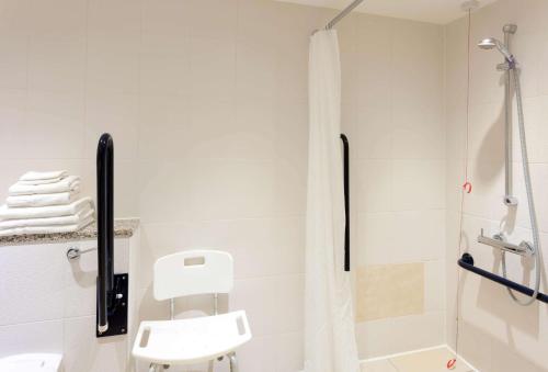 a bathroom with a shower and a sink and a toilet at Hampton by Hilton London Croydon in Croydon