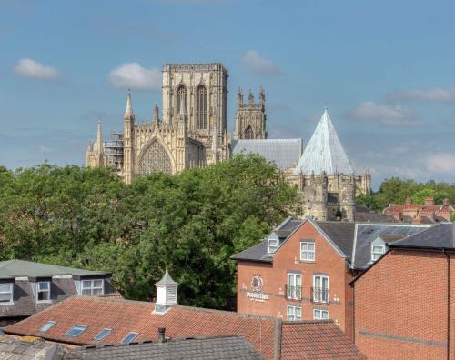 a view of a cathedral and roofs of buildings at DoubleTree by Hilton York in York