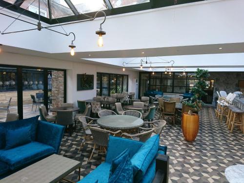 a restaurant with blue furniture and tables and chairs at DoubleTree by Hilton York in York