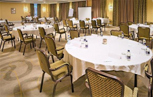a conference room with white tables and chairs at Holiday Inn Kenilworth - Warwick by IHG in Kenilworth