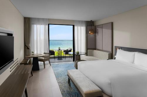 a hotel room with a bed and a view of the ocean at Crowne Plaza Phu Quoc Starbay by IHG in Phu Quoc