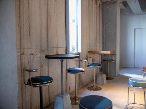 a group of stools in a room with a window at 煎 SEN in Matsue