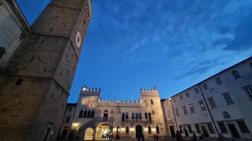 a building with a clock tower in front of it at Casa nostra Capodistria in Koper