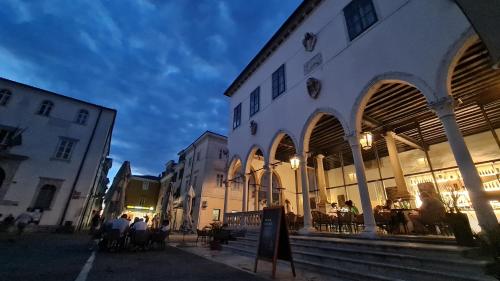 a group of people standing outside of a building at Casa nostra Capodistria in Koper