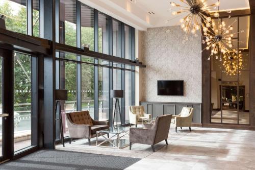 a living room with a chandelier and windows at DoubleTree by Hilton Edinburgh - Queensferry Crossing in North Queensferry