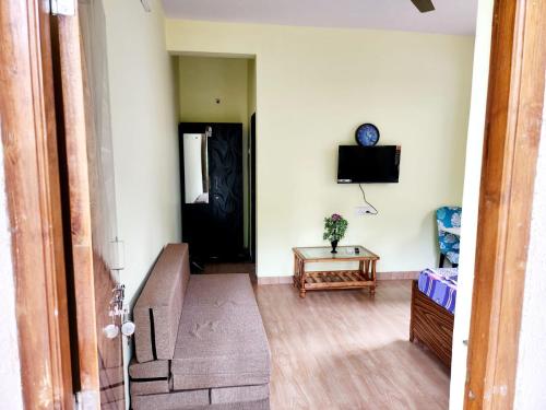 a living room with a staircase and a black door at Bhumi Holiday Home in Alibaug