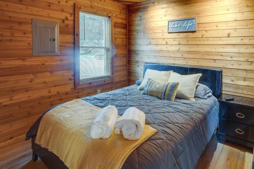 a bedroom with a bed with towels on it at Okauchee Lake Vacation Rental with Boat Dock! in Oconomowoc