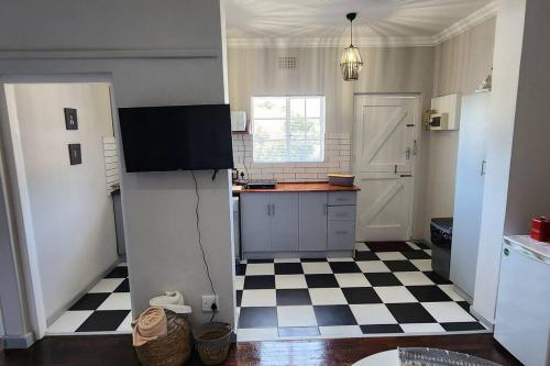 a kitchen with a black and white checkered floor at Ebenezer in Somerset West