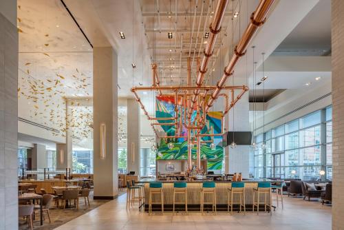 a dining room with a large painting on the wall at Hyatt Regency Denver at Colorado Convention Center in Denver