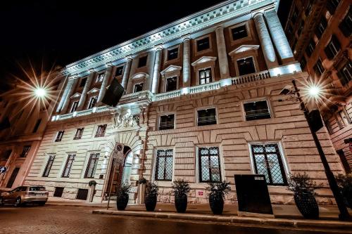a building with lights on the front of it at Aleph Rome Hotel, Curio Collection By Hilton in Rome