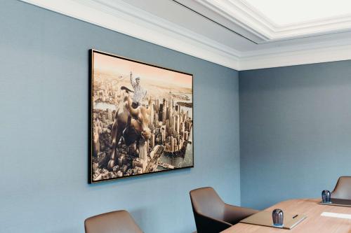 a painting hanging on a wall in a meeting room at Hilton Frankfurt City Centre in Frankfurt/Main