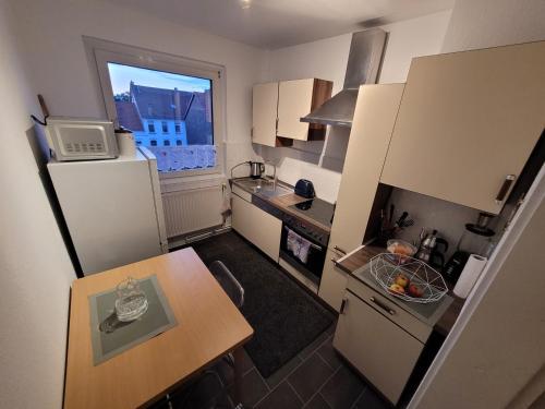 a small kitchen with a table and a window at Apartment mit Ausblick in Braunschweig