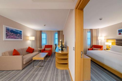 a hotel room with a bed and a couch at Hilton Garden Inn Safranbolu in Safranbolu