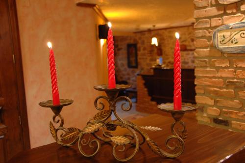 two candles sitting on top of a table at Archontiko Mesohori Meteora in Kalabaka