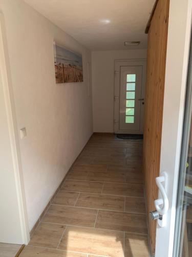 a hallway with a door and a tile floor at Ferienhaus in Lassan vor Usedom in Lassan