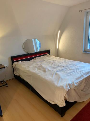 a bedroom with a bed with a mirror on the wall at Ferienhaus in Lassan vor Usedom in Lassan