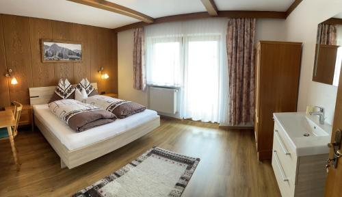 Un dormitorio con una cama grande y una ventana en Appartement Anja, en Fügen