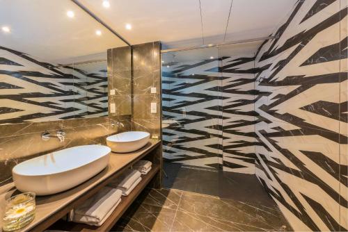a bathroom with a sink and a mirror at Hilton Nicosia in Nicosia