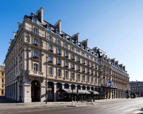 a large building on the side of a street at Hilton Paris Opera in Paris