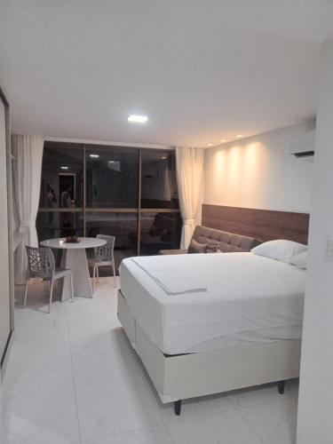 Ένα ή περισσότερα κρεβάτια σε δωμάτιο στο Aconchegante Flat na Beira Mar do Cabo Branco