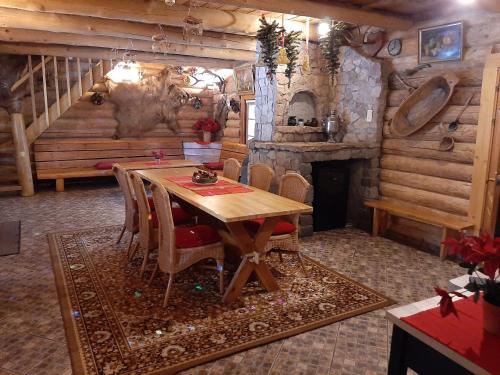 a dining room with a table and a fireplace at Brīvdienu māja Mētriņi in Ķekava