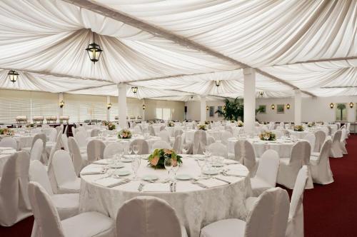 a large white tent with white tables and chairs at Hilton Rome Airport in Fiumicino