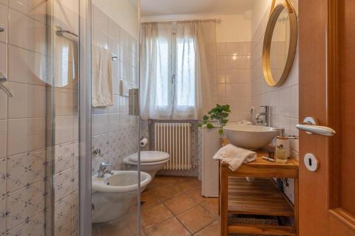 a bathroom with a toilet and a sink and a shower at Casa Orizzonte - Appartamento con vista in Gabicce Mare