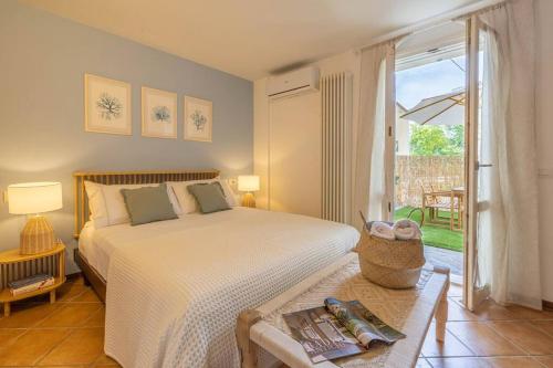 a bedroom with a bed and a table and a window at Casa Orizzonte - Appartamento con vista in Gabicce Mare