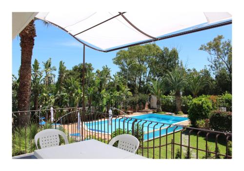 a view of the pool from the patio of a villa at The Green Seaside in Fondachello