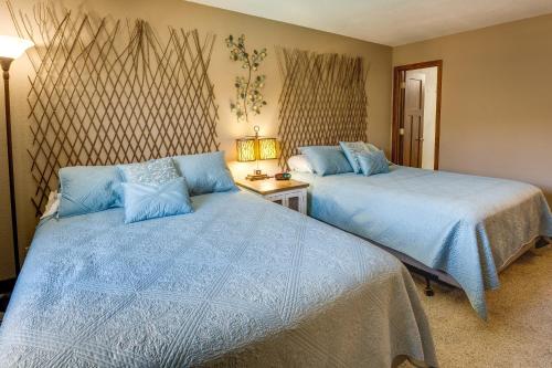 a bedroom with two beds with blue pillows at Cozy Condo with Resort Perks - Half Mi to Beach! in Lake Havasu City
