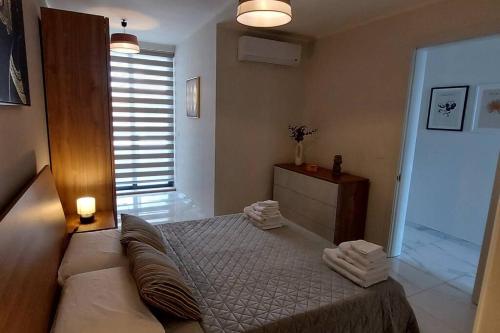 a bedroom with a bed with towels on it at 2-bed apartment in Mellieha in Mellieħa