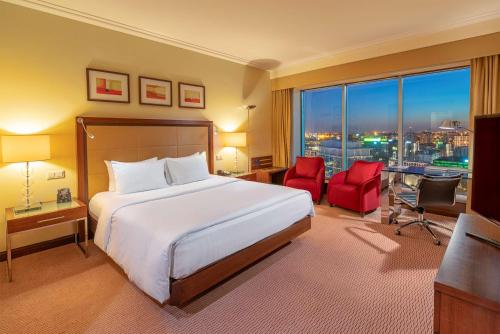 a hotel room with a bed and a large window at Hilton Warsaw City Hotel in Warsaw