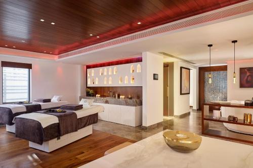 a large bedroom with two beds and a tub at Parklane, a Luxury Collection Resort & Spa, Limassol in Limassol