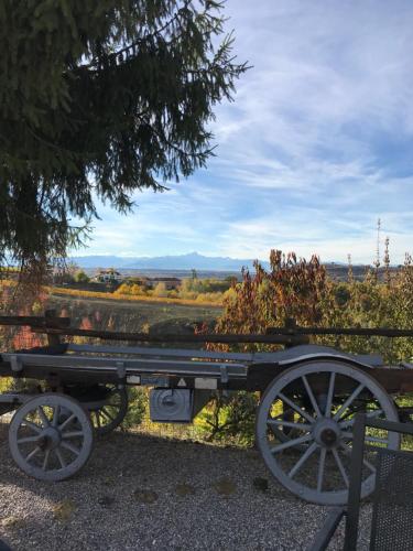 a wagon parked in front of a field at Agriturismo Bric di Gai in Monforte dʼAlba