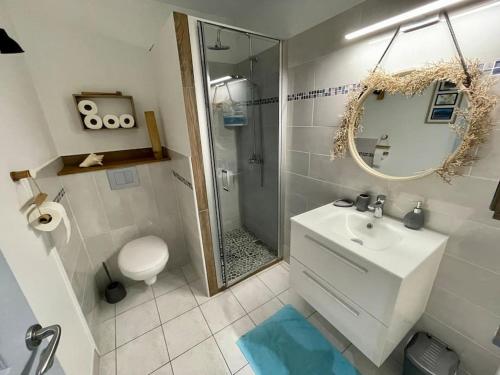 a bathroom with a sink and a shower and a mirror at Sous les Tropiques…Vue mer in Les Trois-Îlets