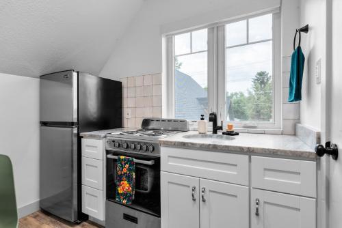 a kitchen with a stove and a refrigerator at Stylish Studio in Heber City in Heber City