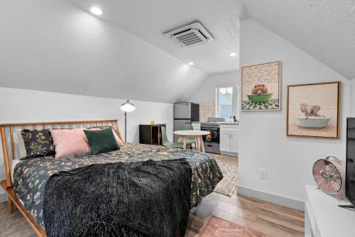 a bedroom with a large bed and a kitchen at Stylish Studio in Heber City in Heber City