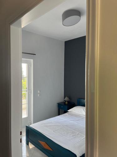 a small bedroom with a bed and a window at Krinides Place in Nerotriviá