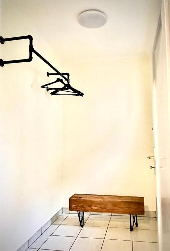 a bench in a room under a light fixture at Rebenlaub in Heringen