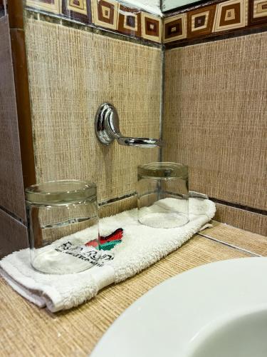 a bathroom counter with a towel and a sink at Rupa Rupa High Jungle Eco B&B in Machu Picchu