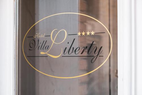 a glass door with a gold circle with the words and wildlife eternity at Hotel Villa Liberty in Pontecurone