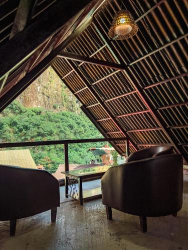 a room with two chairs and a table and a ceiling at Rupa Rupa High Jungle Eco B&B in Machu Picchu