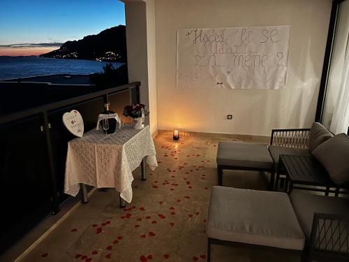 a balcony with a table with a candle on it at Ivana&Luka-Put luke 1, Brela in Brela