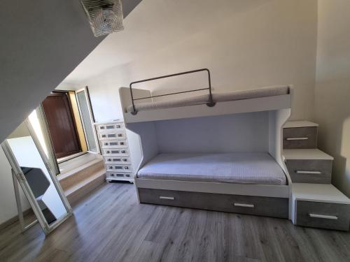 a bedroom with a bunk bed in a room at Matilde home in Martinsicuro