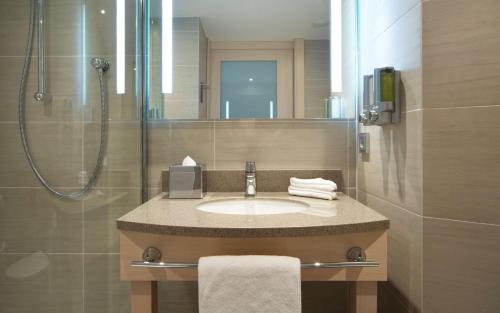 y baño con lavabo y ducha. en Hampton by Hilton Moscow Strogino, en Moscú