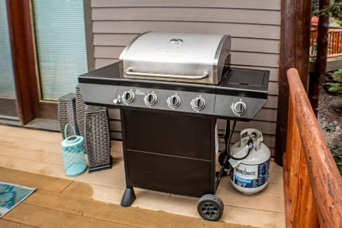 a grill sitting on a porch next to a house at Juniper Bay Getaway in Somers