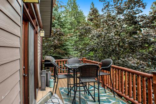 a balcony with four chairs and a table at Juniper Bay Getaway in Somers