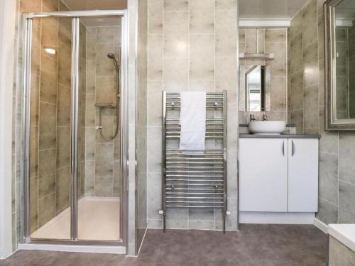 a bathroom with a shower and a sink at The Oxfordshire in Blackpool