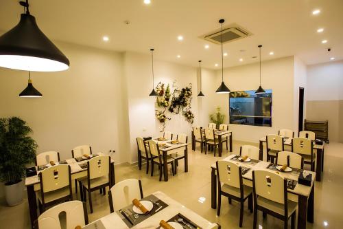 a restaurant with tables and chairs in a room at Tuong Vi 2 in Hai Phong