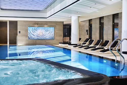 a pool in a hotel lobby with a swimming pool at Hilton Tallinn Park in Tallinn